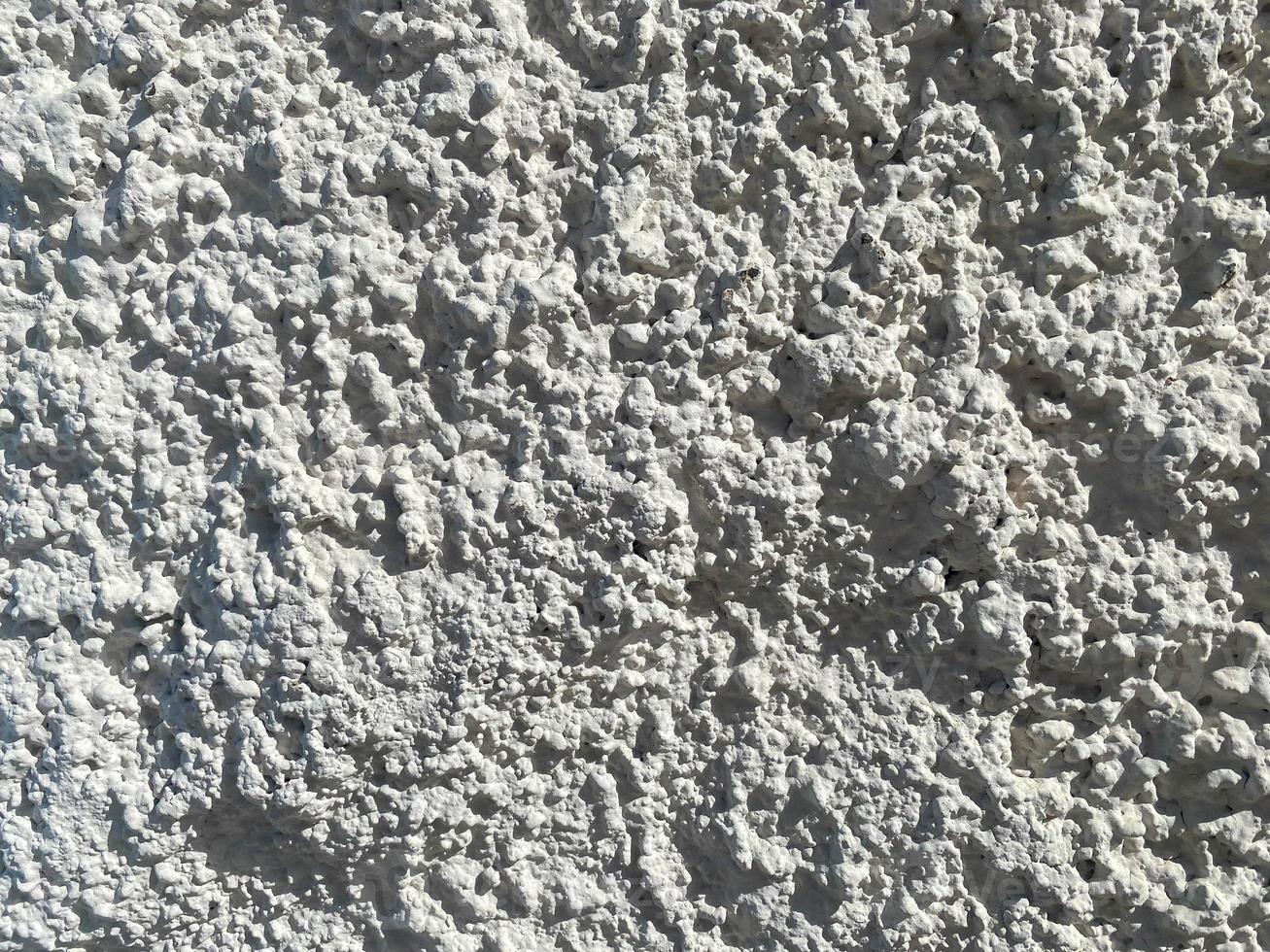The texture is the background of a white decorative facade volumetric shurpaty plaster bark beetle. The background photo