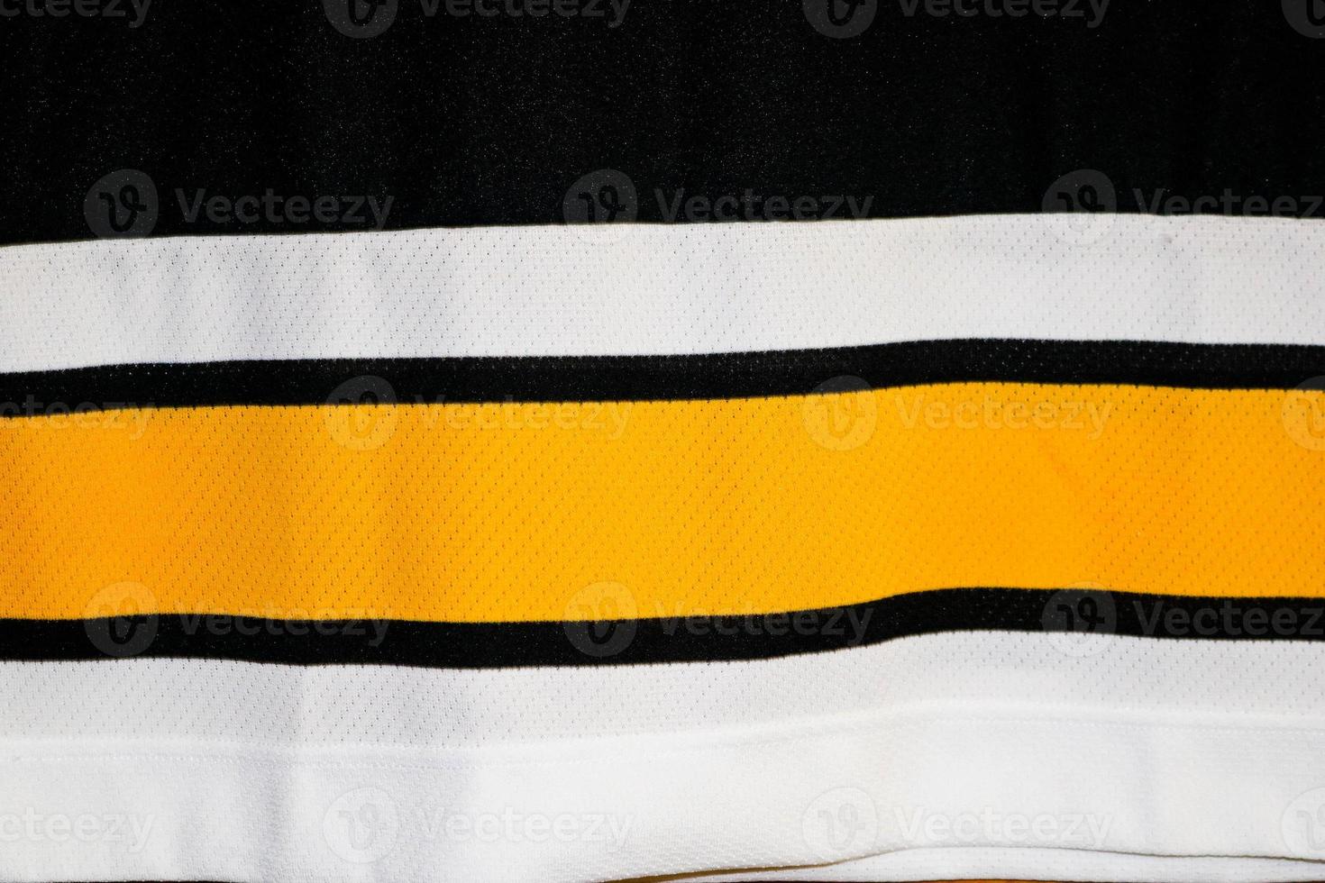 Texture of a multi-colored white yellow black synthetic German fabric. The background photo