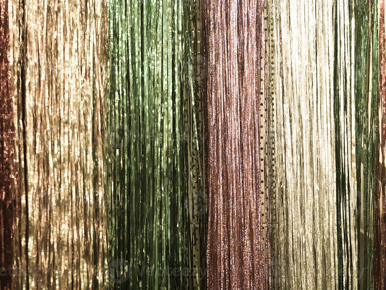 Festive multicolored rainbow shiny silver beautiful Christmas plastic garland sparkling for the New Year, Christmas-tree tinsel, festively decorated. Texture. Background photo