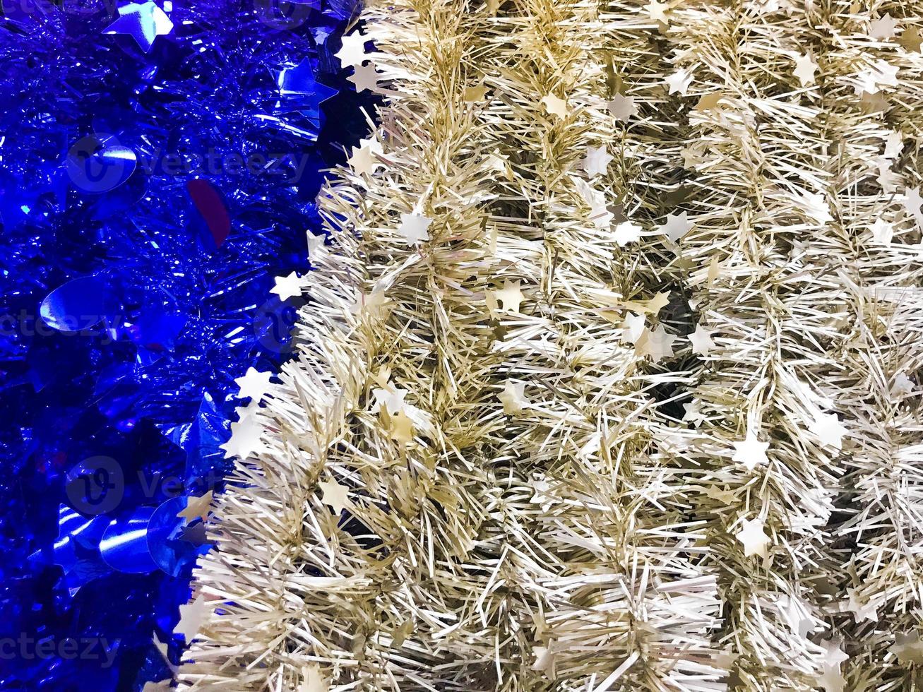 Festive gray silver beautiful Christmas plastic garland sparkling for the New Year, Christmas-tree tinsel, festively decorated. Texture. Background photo