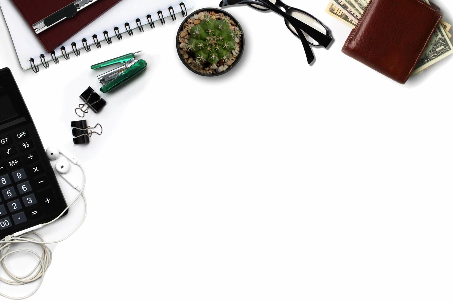 White office desk with calculator, wallet, and supplies. Top view with copy space photo