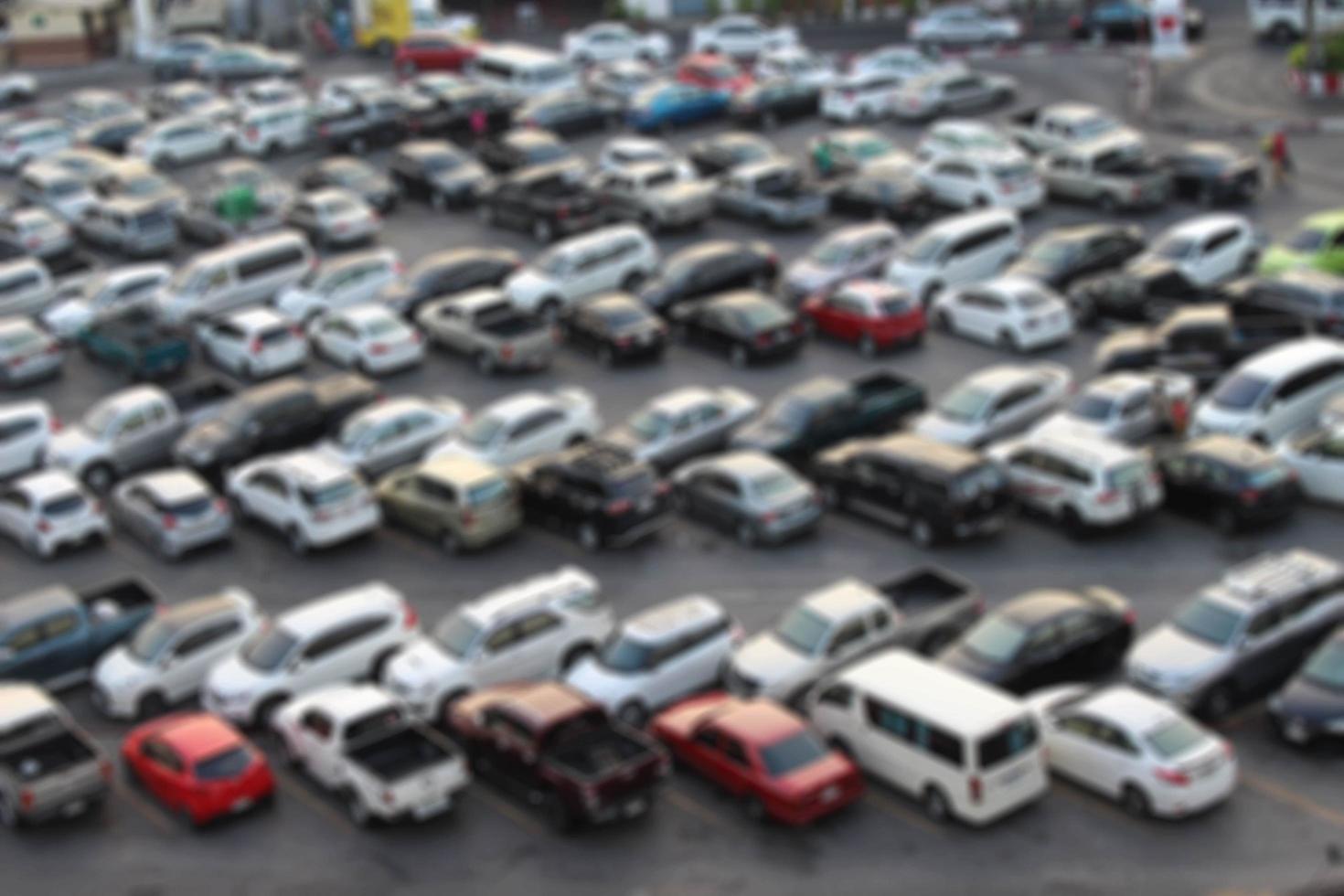 blurred outdoor parking lot full of cars for background use photo