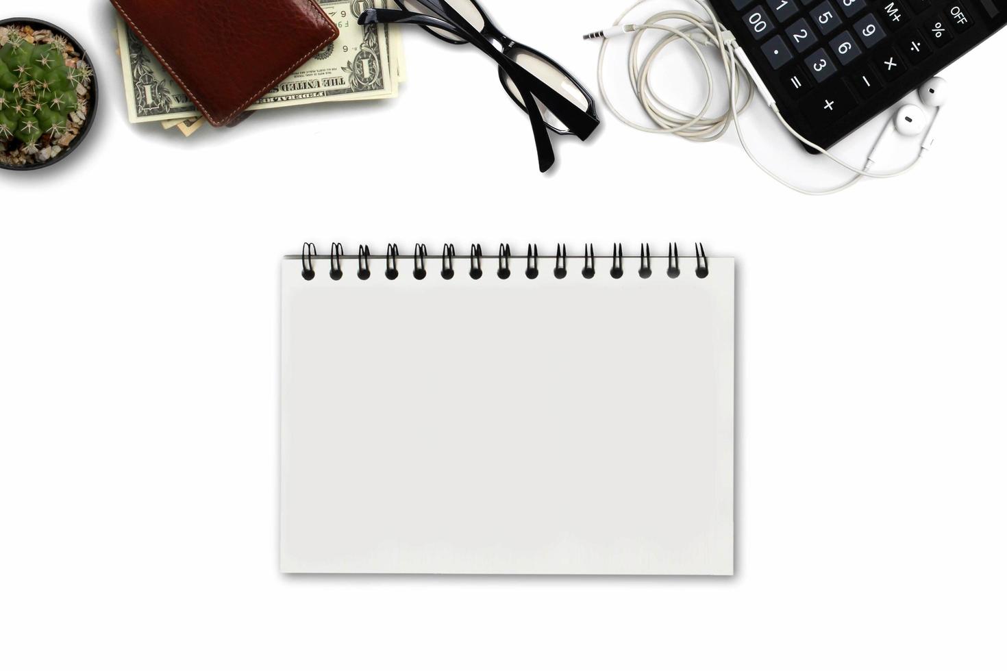 White office desk with US Dollars Count , calculator, wallet, and supplies. Top view with copy space photo