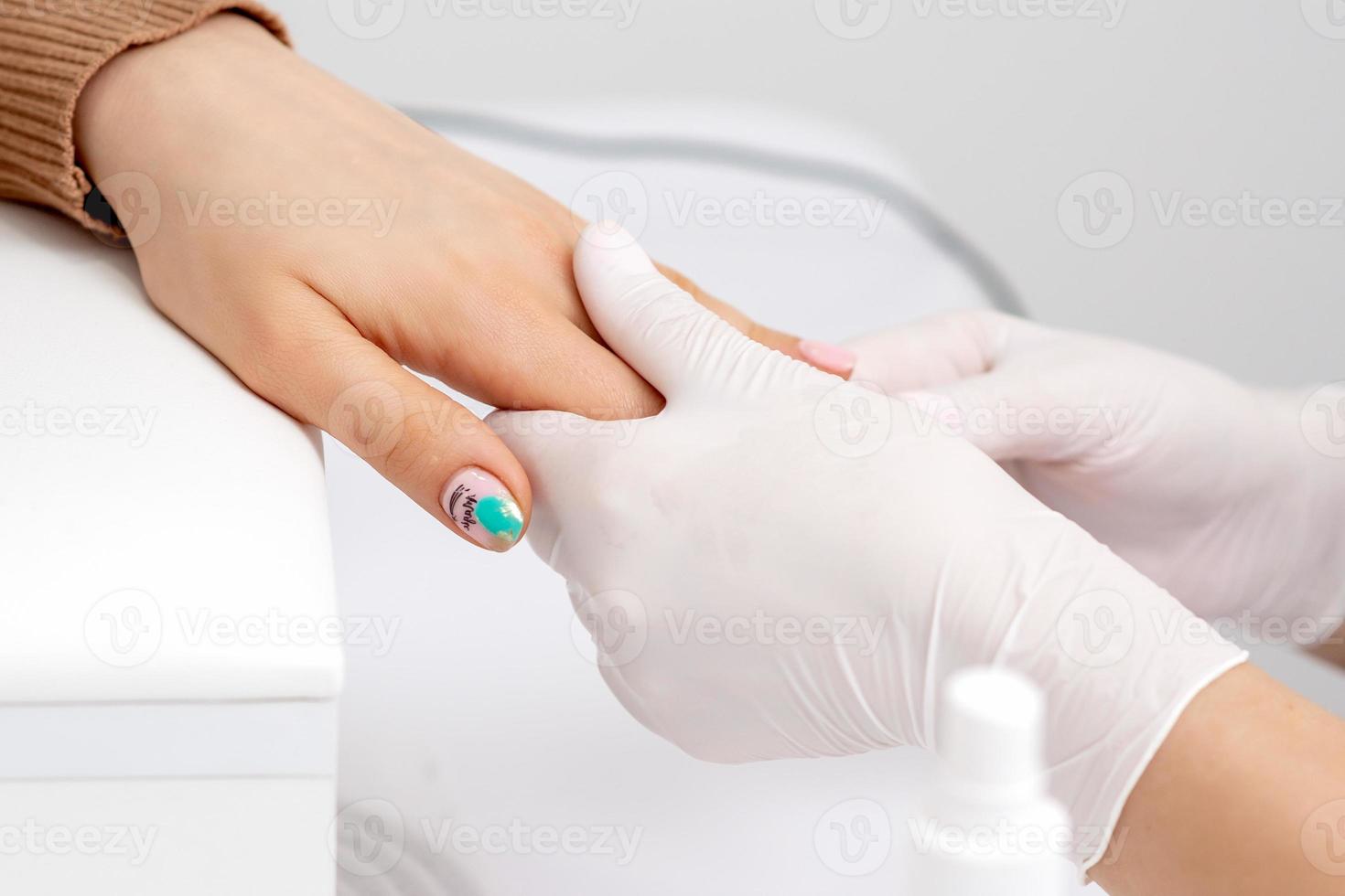 Female hand receiving hand massage photo