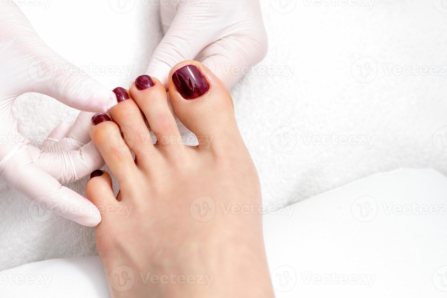 human hands holding painted toenails photo