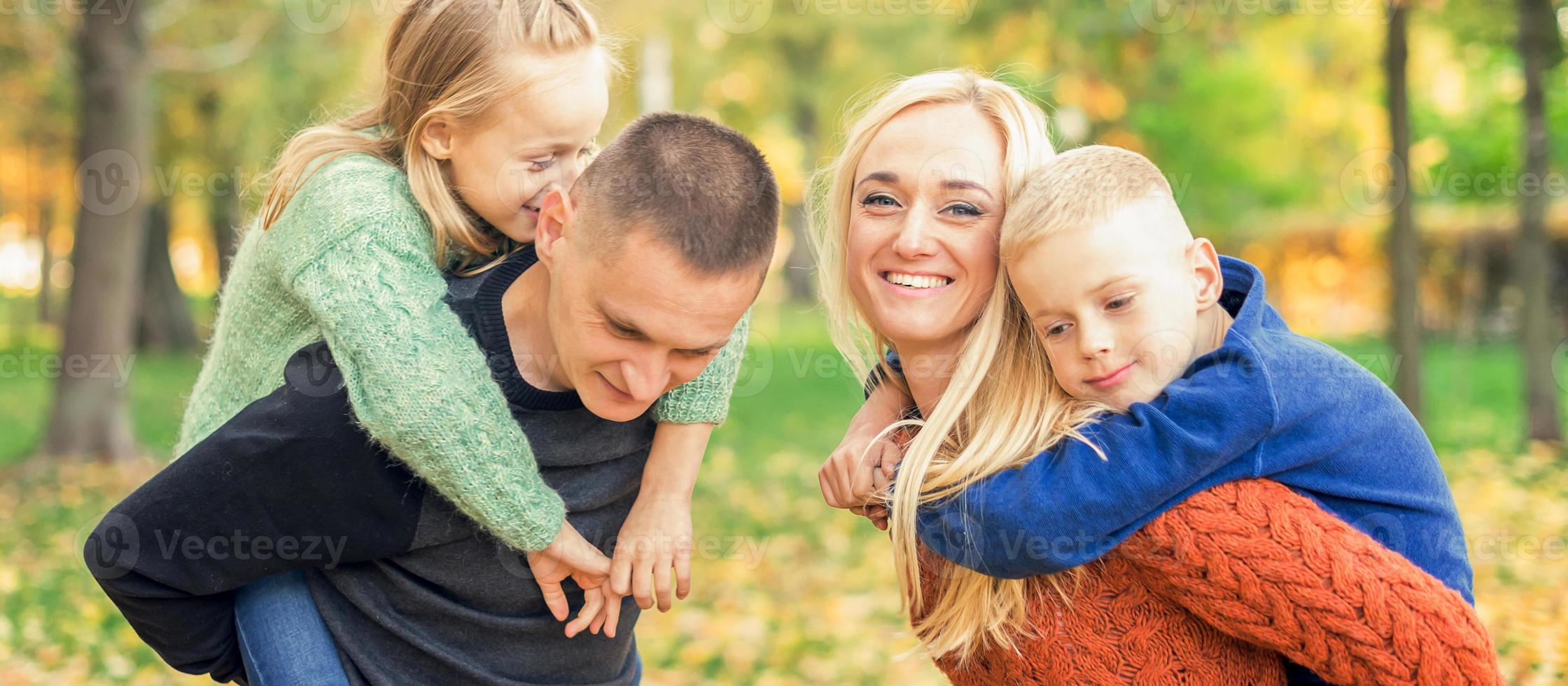 Portrait of young family in autumn park photo