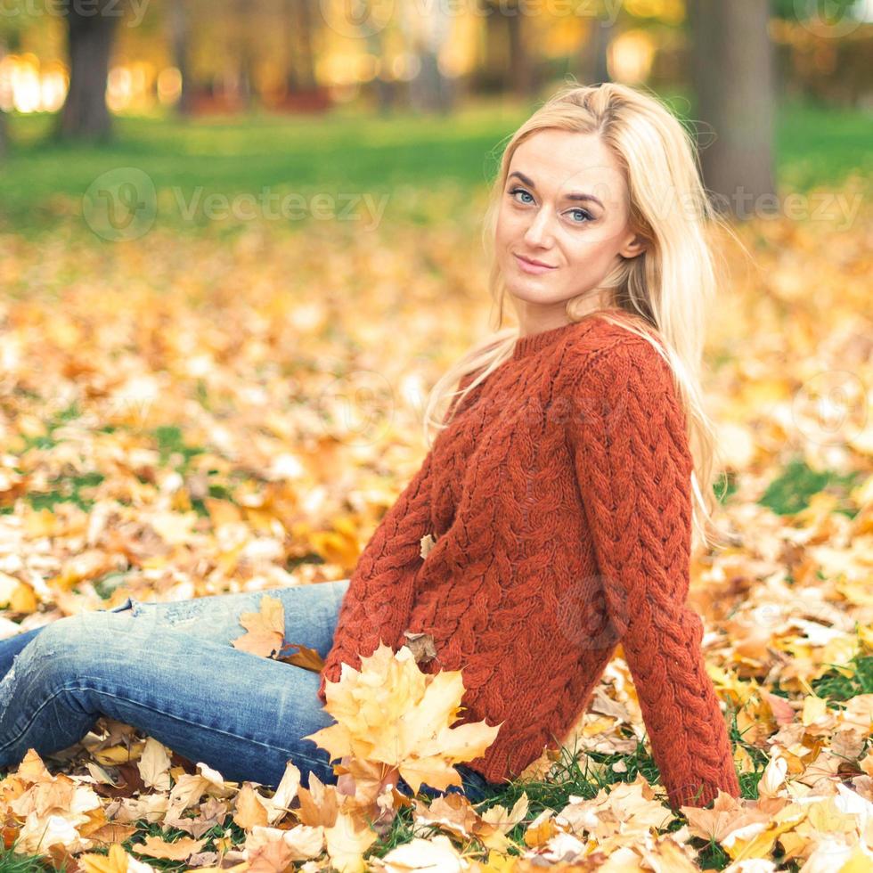 Young woman in park on autumn day photo
