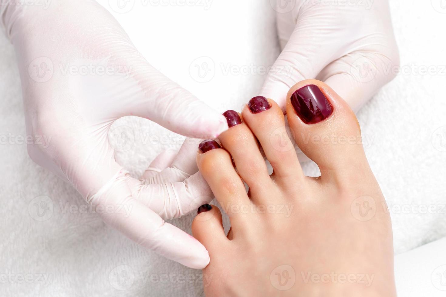 human hands holding painted toenails photo