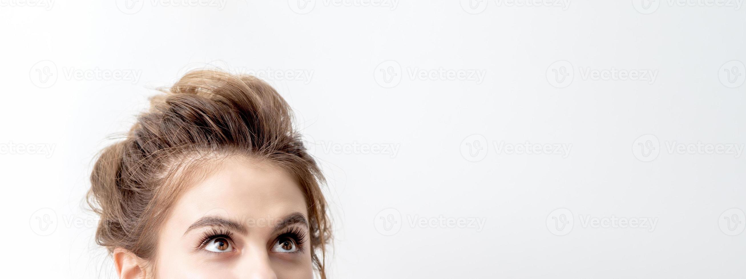 Woman looking up on white background photo