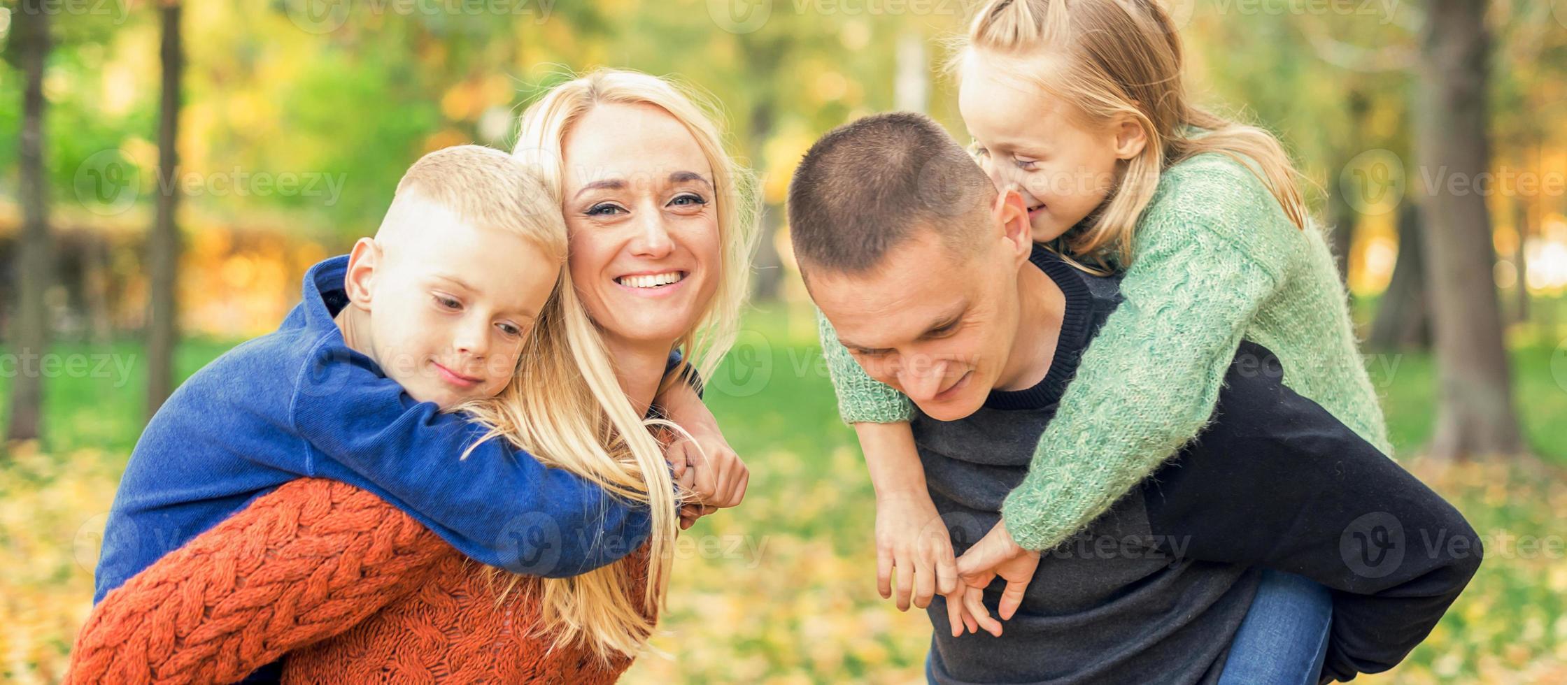 Portrait of young family in autumn park photo