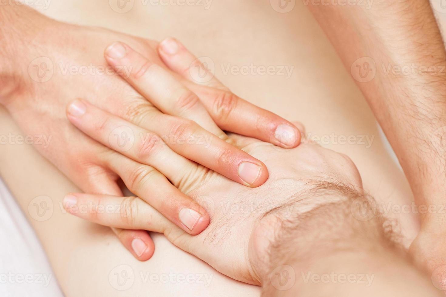 Hands doing back massage. photo