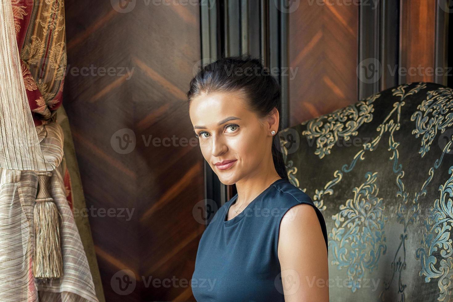 Woman sitting in an armchair. photo