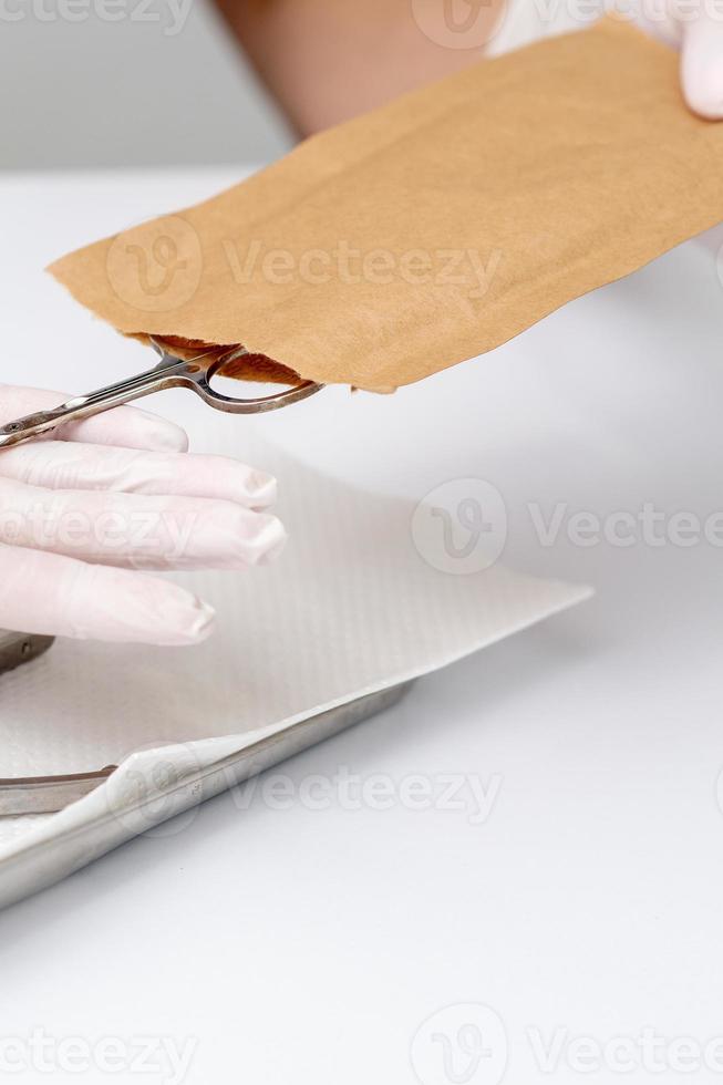 Manicurist hands taking manicure tools photo