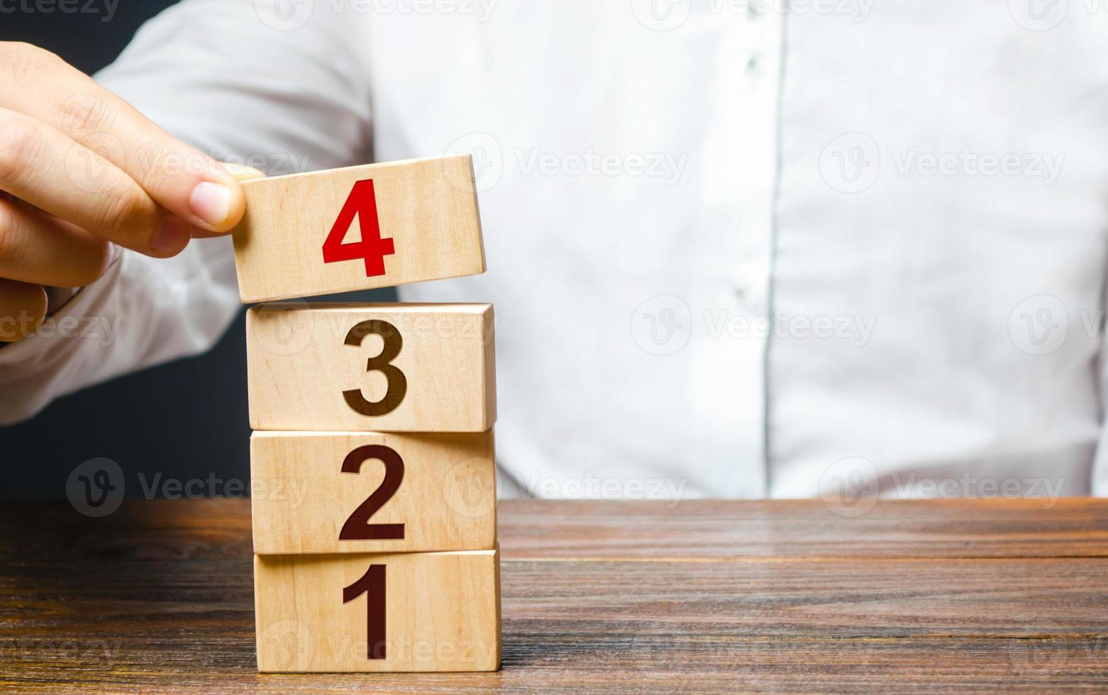 A man builds a tower of numbered blocks. Alternate items and conditions for implementation. Contract agreement road map. Organization and systematization, step by step instructions. Create order photo