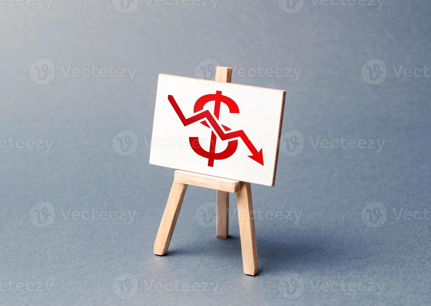 A stand with a canvas and a red dollar arrow down. The concept of falling rates and indicators of the economy or production. low prices and falling demand, recession. The bad situation in the markets photo