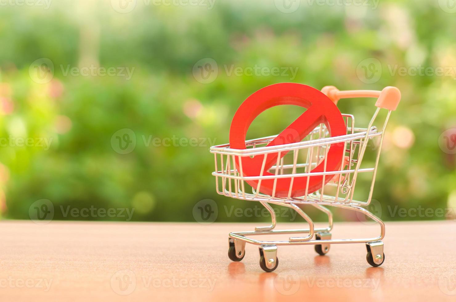 Red Prohibition symbol NO on a supermarket trading cart. Embargo, trade wars. Restriction on the importation of goods, proprietary for business. Inability to sell products, ban imports. No delivery. photo