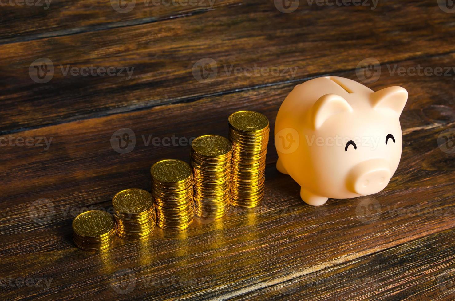 Increasing stacks of coins and a piggy bank. Increase savings, placing deposits in a bank. Loyalty program, accumulative system. Crowdfunding startups investing. Profit income. Retirement and pension photo