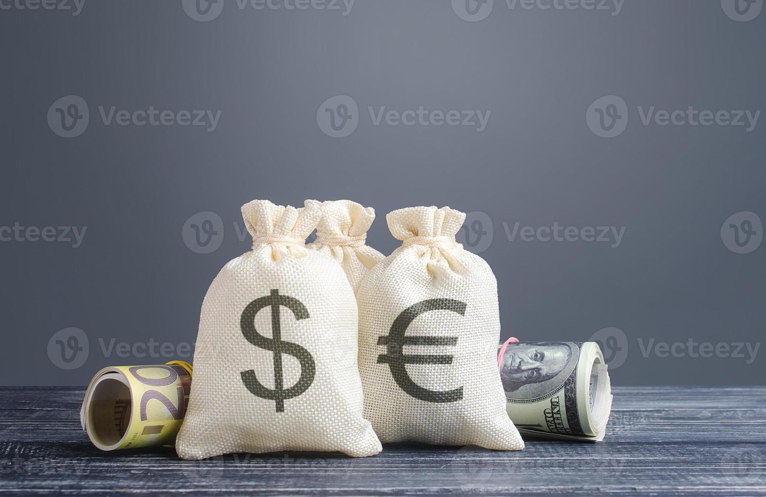 Money bags and world currencies. Capital investment, savings. Economics, lending business. Profit income, dividends payouts. Crowdfunding startups investing. Banking service, budget monetary policy photo