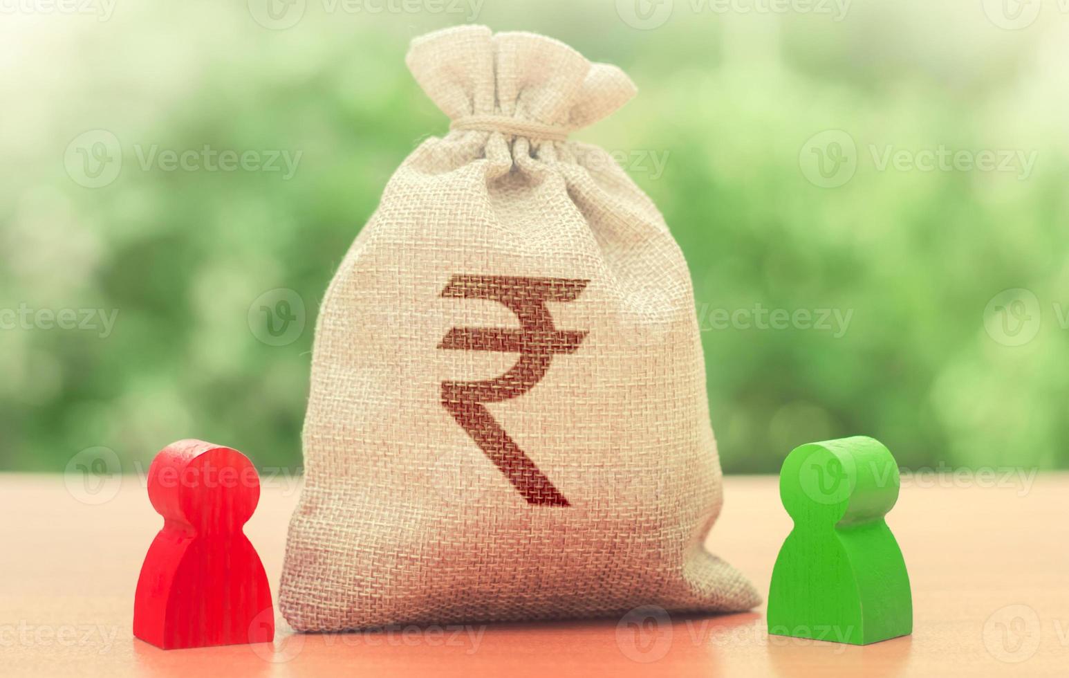 Indian rupee money bag and a deal between two persons. Business lending, leasing. Tender competitiona contract. Trade agreement. Negotiation process dealings. Dispute solution. Finance surety promise photo