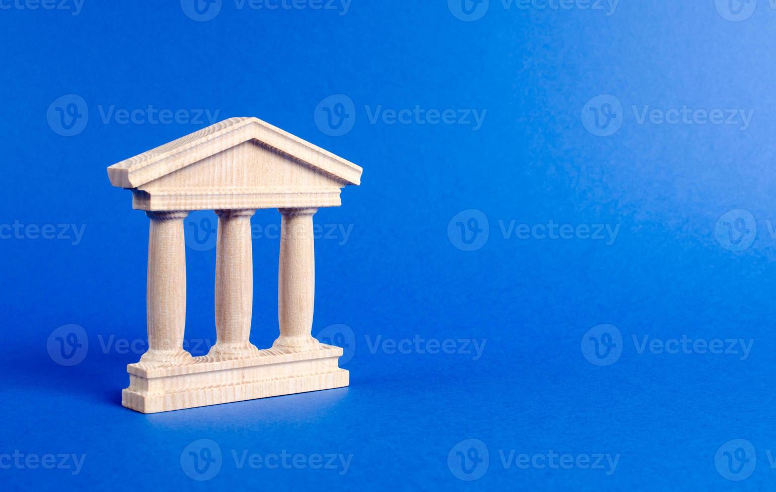 Building figurine with pillars in antique style. Concept of city administration, bank, university, court or library. Architectural monument in the old part of the city. Banking, education, government. photo