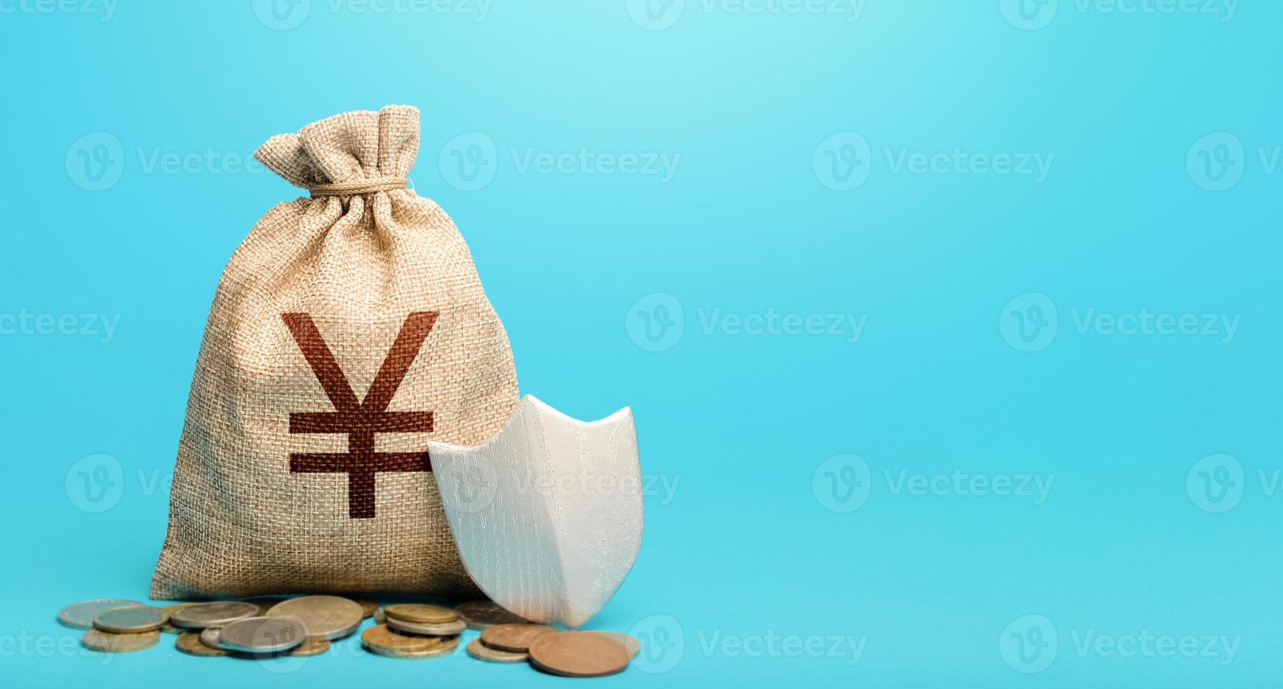 Yuan Yen money bag and protection shield. Guarantee of protection of means of savings and investments. Secured loan. Ease doing business. Avoiding loss of funds during inflation. Financial instruments photo