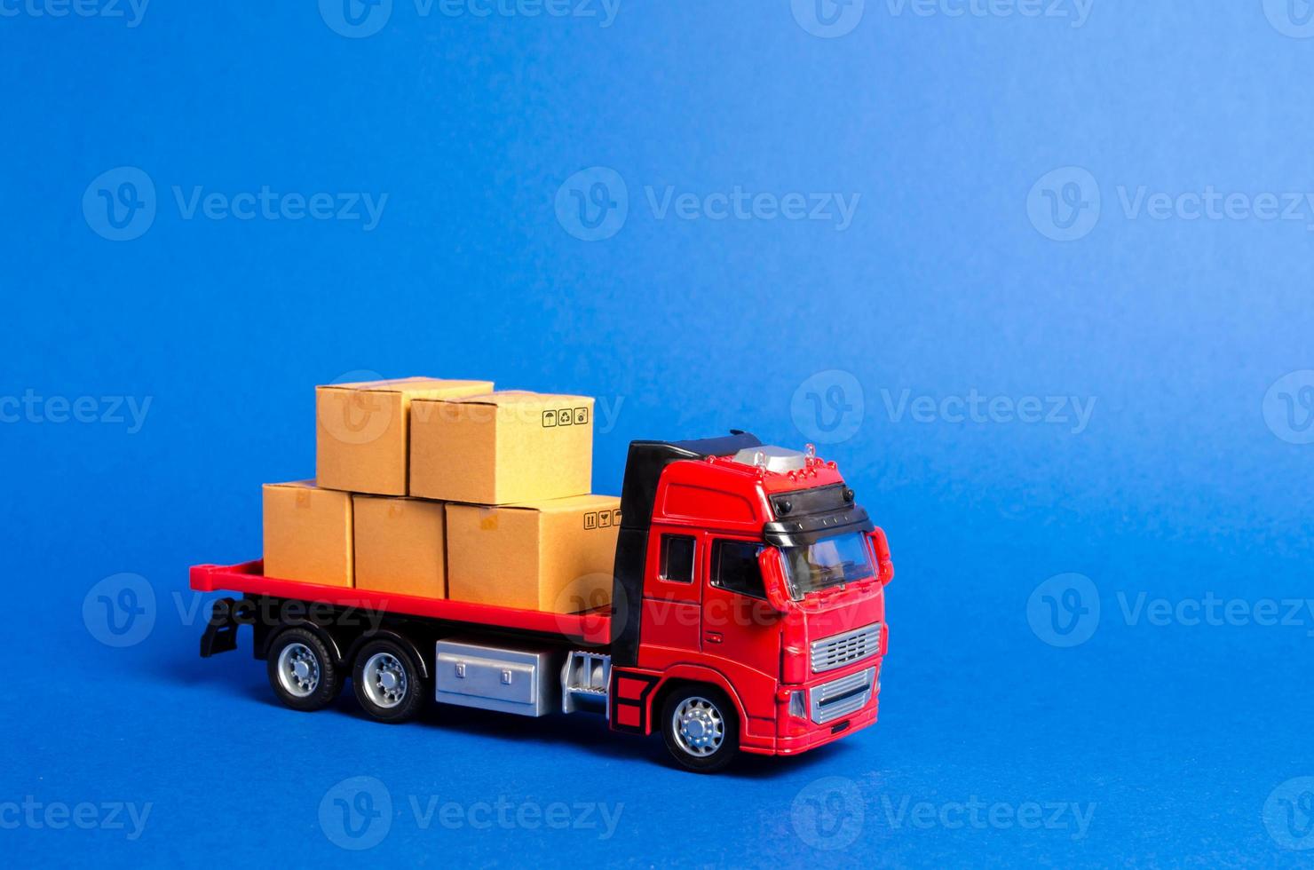 A red truck loaded with boxes. Services transportation of goods and products, logistics and infrastructure. Transportation company. Warehousing and supply. Optimization of delivery logistics. photo