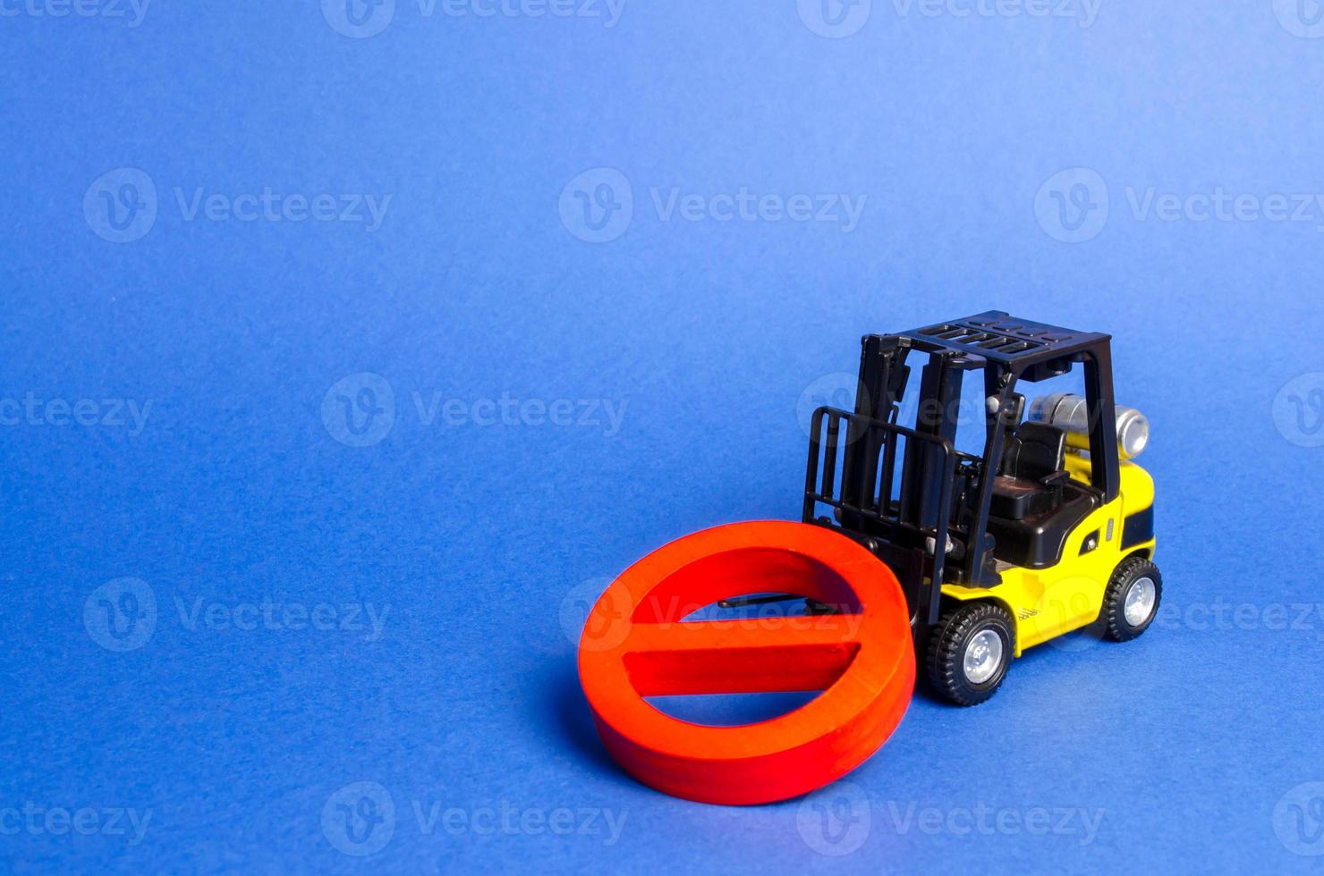 A yellow forklift truck cannot lift a red NO symbol. The concept of prohibition, sanctions and restrictions. Overcoming, bypassing difficulties. solving complex engineering and technical problems photo