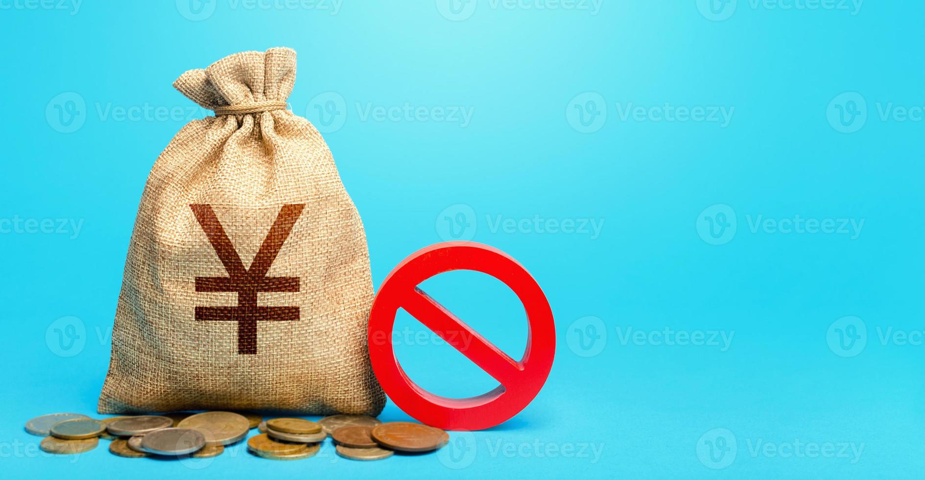 Yuan Yen money bag and red prohibition sign NO. Confiscation of deposits. Termination funding for projects. Monitoring suspicious money flows. Monetary restrictions, freezing seizure of bank accounts. photo