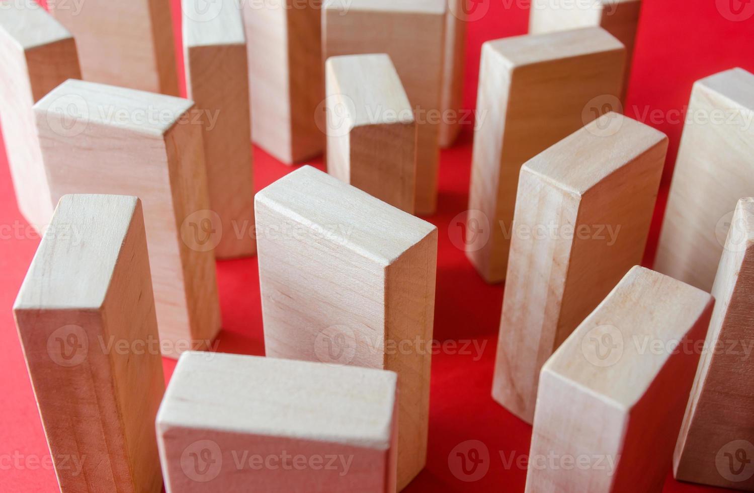 Wooden blocks on a red background. Concept of a maze labyrinth of wardrobes or dense urban construction. View from above. Barriers and obstacles. Objects and structures. photo