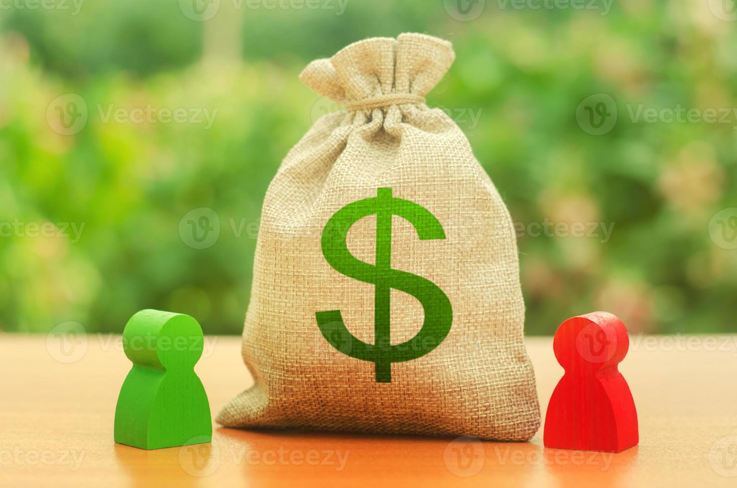 Money bag with dollar symbol and two people figures. Business Dispute and its solution between two businessmen. division of property and divorce. Investment and lending, leasing. Business relationship photo