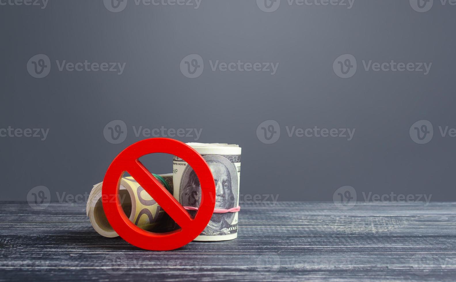 Money bundle rolls blocked by red prohibition symbol no. Capital export outflow restrictions. Sanctions. Regulatory laws in financial sector. Diversification foreign gold currencies exchange reserves. photo