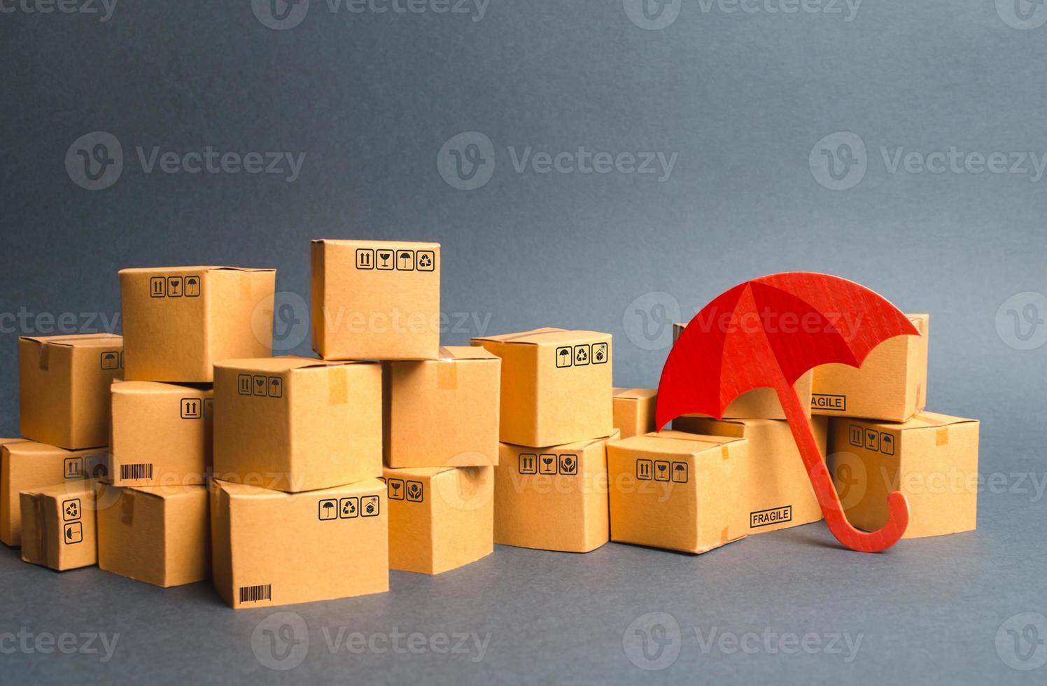 Many cardboard boxes and umbrella. concept of insurance purchases. Protection. Support of the national manufacturer by government. Providing warranty on purchased products. Consumer rights photo