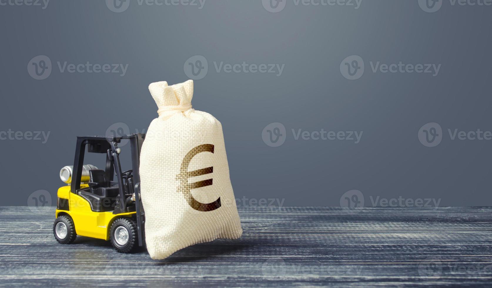 Yellow forklift carries a Euro money bag. Grants financing. Payment of taxes. Big contract, profitable deposit, take a loan. Inflation, price increases. Wealth, investments in economy. financial aid photo