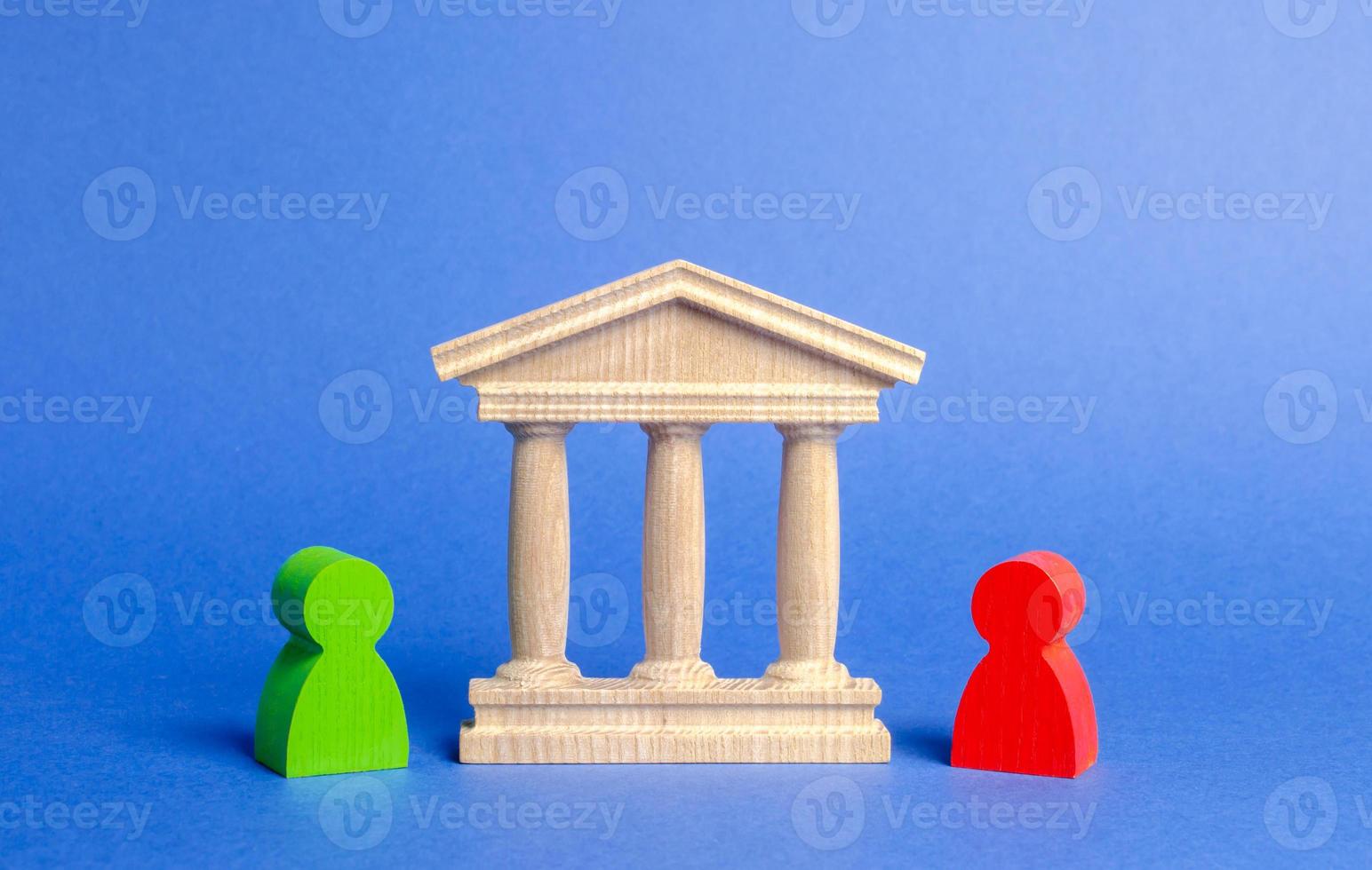 Figures of people stand near the government building, court, bank. rivals. Confrontation and conflict resolution through court. Activity through regulatory authorities or a bank. role of the mediator photo