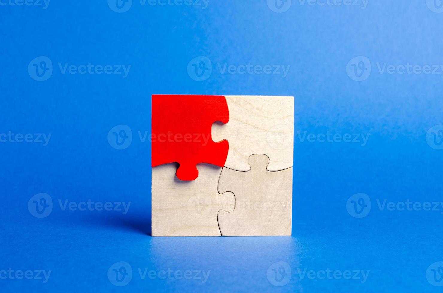 Wooden puzzles on a blue background. One puzzle is different. Individual opinion. Stand out from the crowd. Uniqueness. Divergent views. Different concepts to other people. Place for text. photo