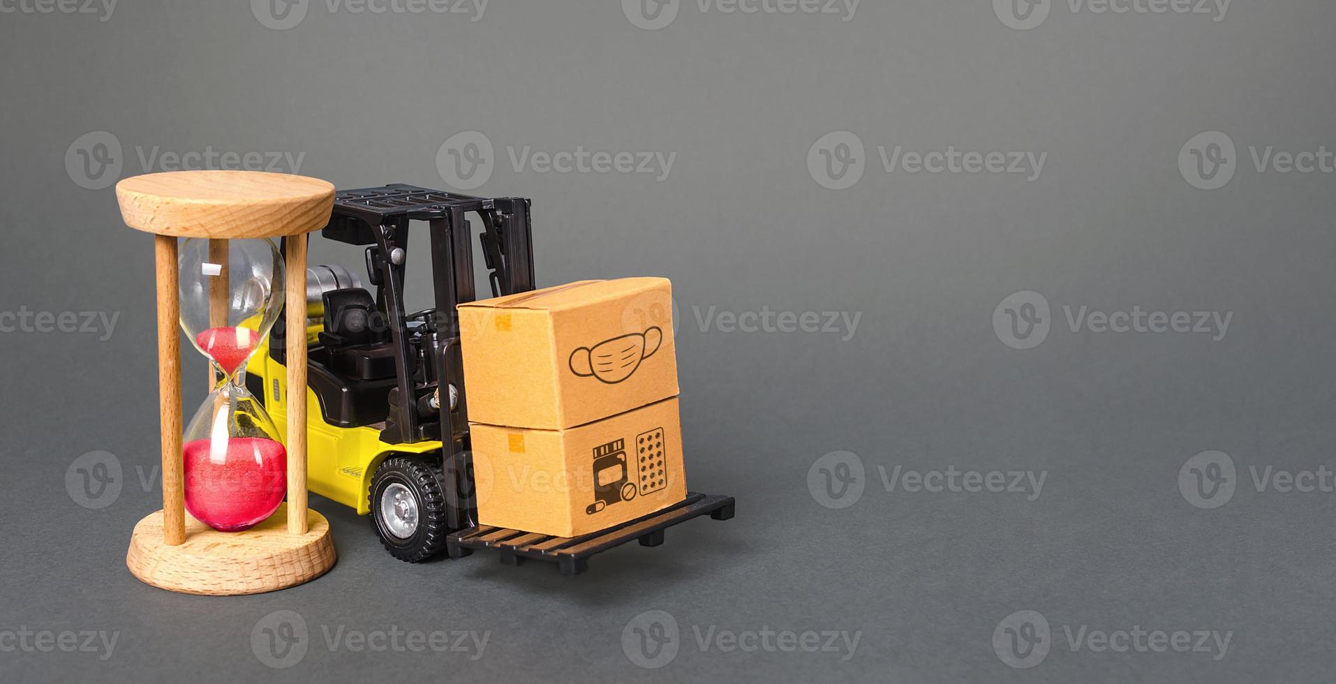 Forklift with boxes and hourglass. Urgent delivery of medicines and medical protective masks. Supply hospitals and populations to stop spread COVID-19 coronavirus, contain padnemia. Express shipping photo