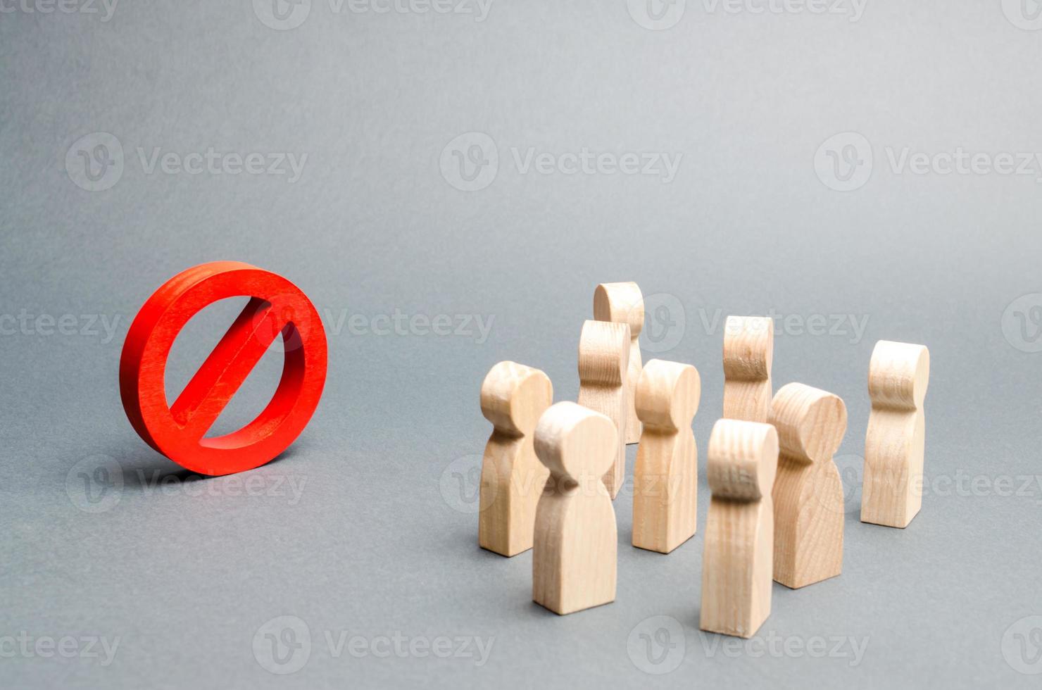 A crowd of people looks at the red sign NO. Overton window. prohibition, taboo, prohibition and rejection. Conservatism, misunderstanding new. Laws Restrictions of rights and freedoms. Selective focus photo