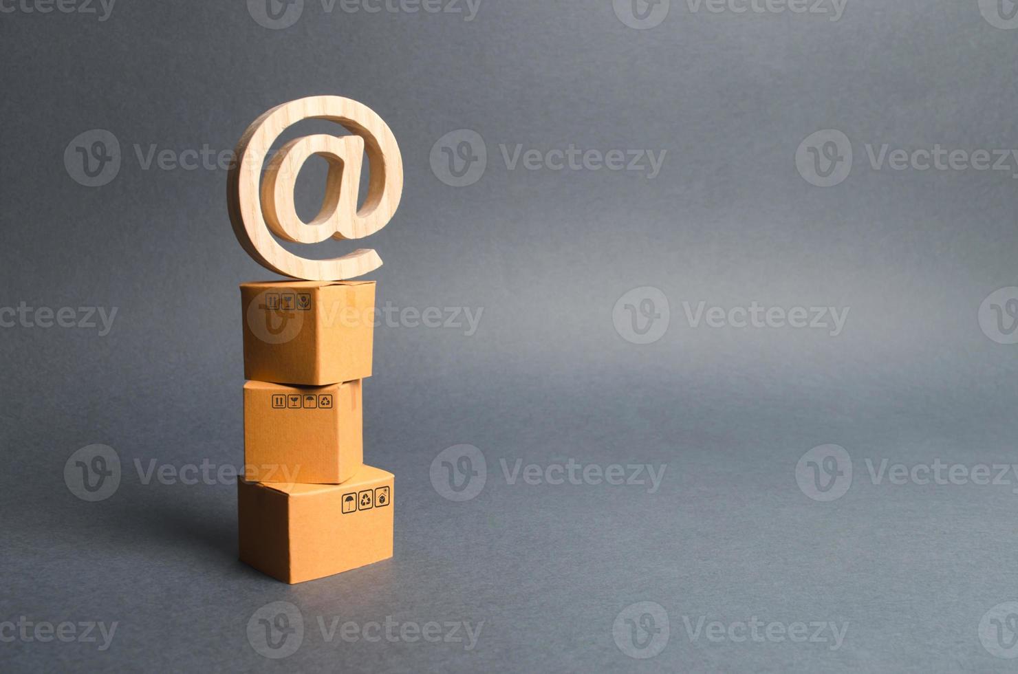 Pile of cardboard boxes and email symbol commercial AT. shopping online. development of Internet network trade, advertising services. E-commerce. sales of goods through online trading platforms. photo