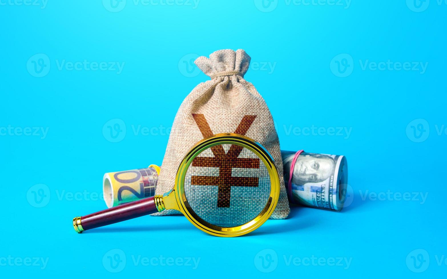 Chinese yuan or japanese yen money bag and magnifying glass 