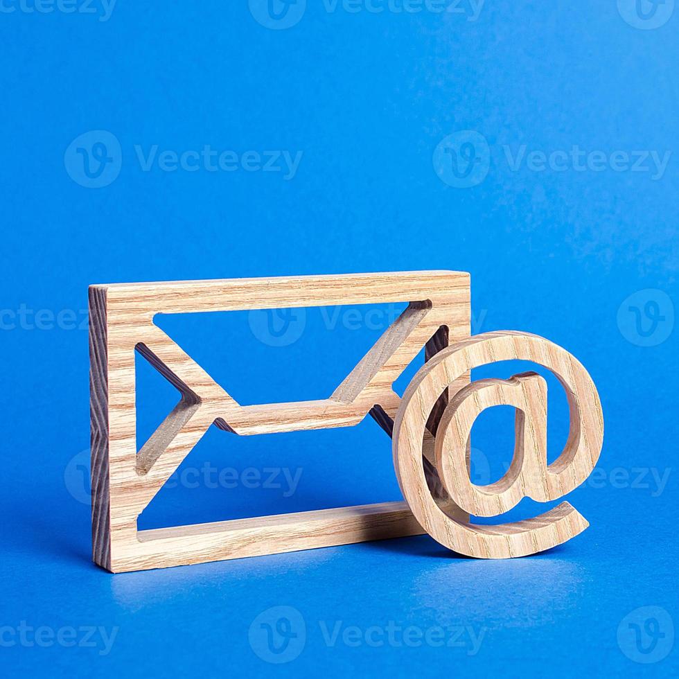 Envelope and email symbol on a blue background. Concept email address. Internet technologies and contacts for communication. Communication over the network, business and correspondence. photo