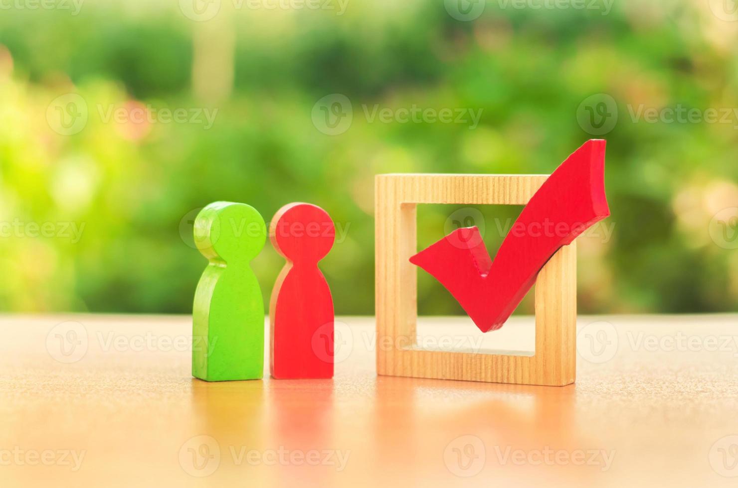 Two opposing candidates of people stand near checkmark vote. Election race. democratic process, elections. political Populism. referendum. Volunteers, parties, constituency electorates. Human rights. photo
