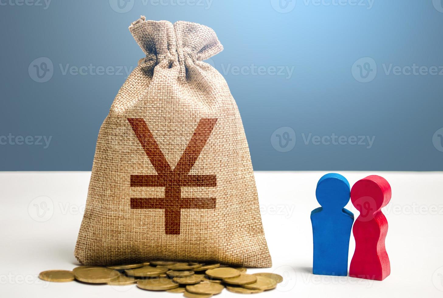 Couple figurines and chinese yuan or japanese yen money bag. Social policy to encourage family creation. Social research, consumer preferences. Segmentation. Marketing and targeting. Demographic grant photo