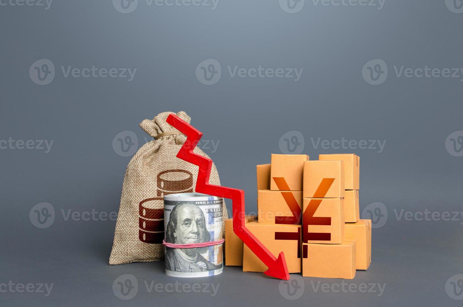 Chinese yuan or japanese yen money with goods and an arrow down. Falling profits. Reduction in consumption, trade imbalance. Low sales. National economy fall. Production decline. Import export. Taxes photo