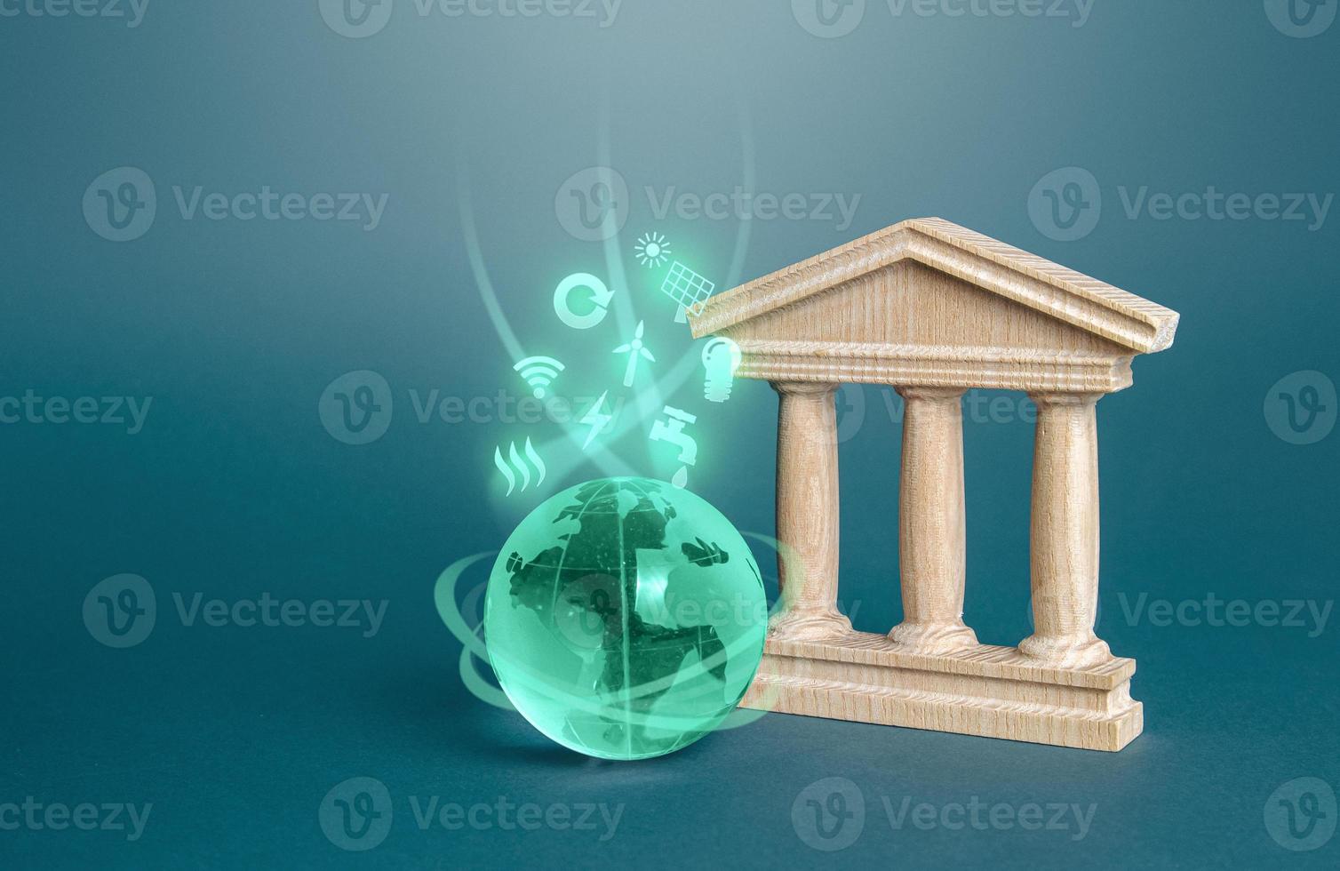 Government state building and globe with environmental symbols. Energy efficiency politics, autonomy, renewable resources economy. Investments in innovative technologies. Financing of green projects. photo