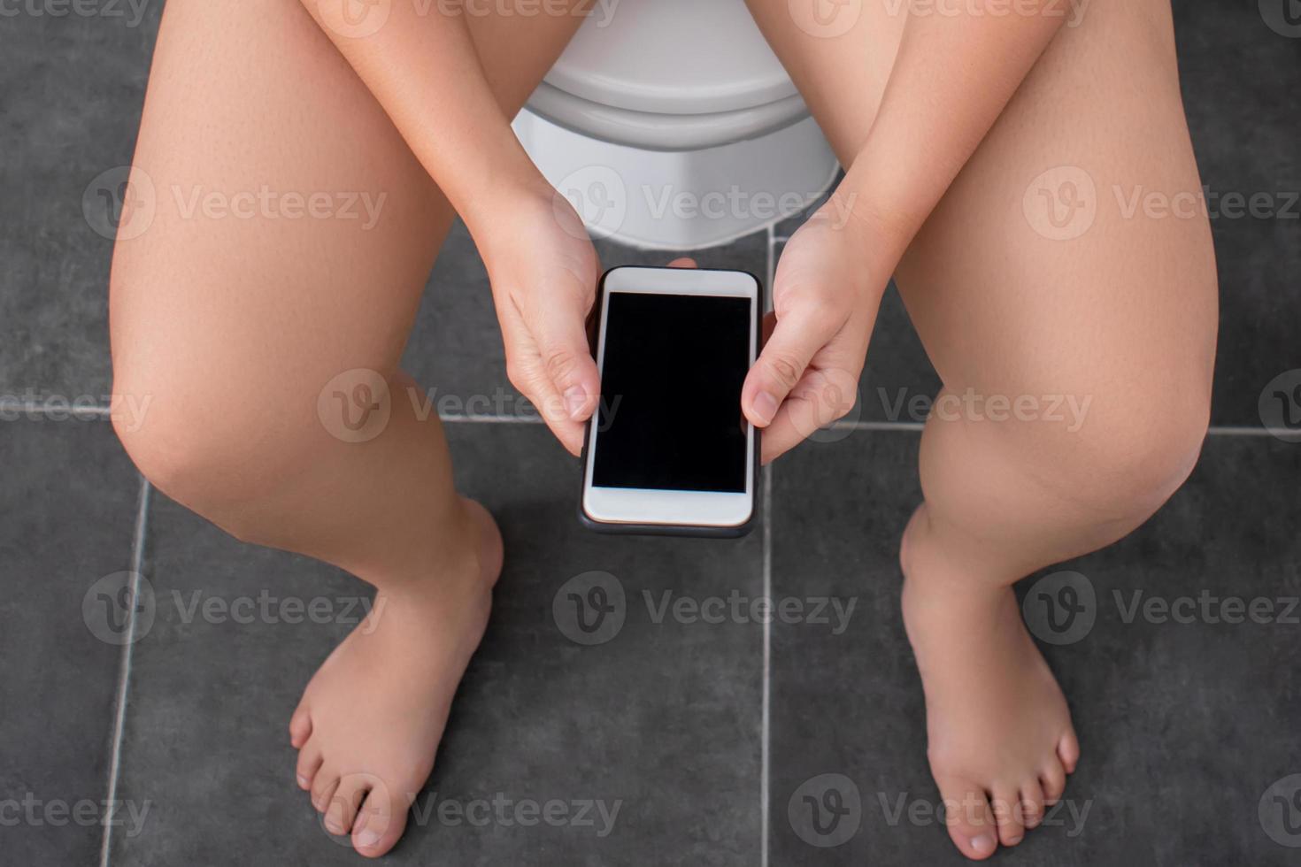 People are using a smartphone at toilet. Top view. photo