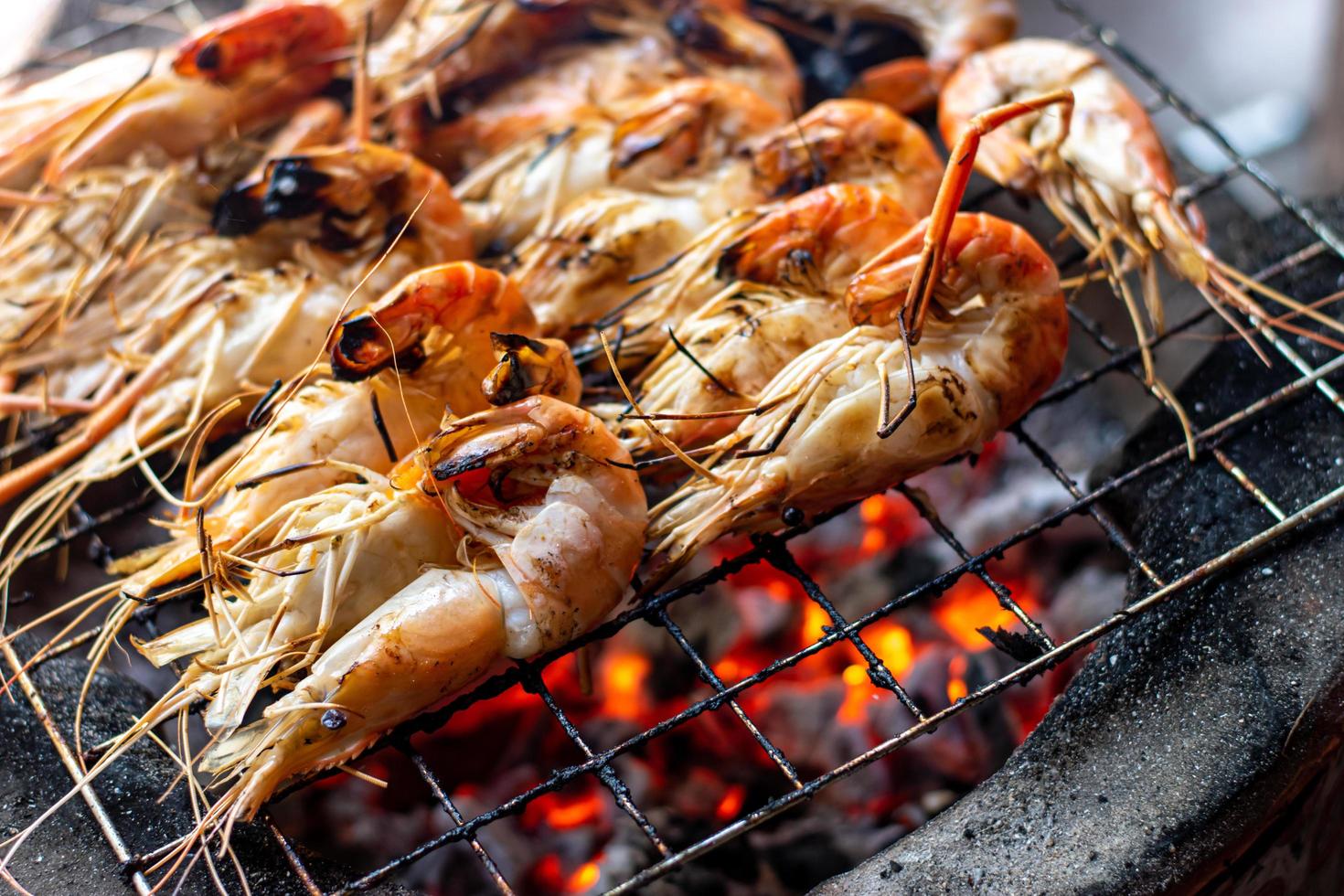Grilled shrimp on charcoal stove photo