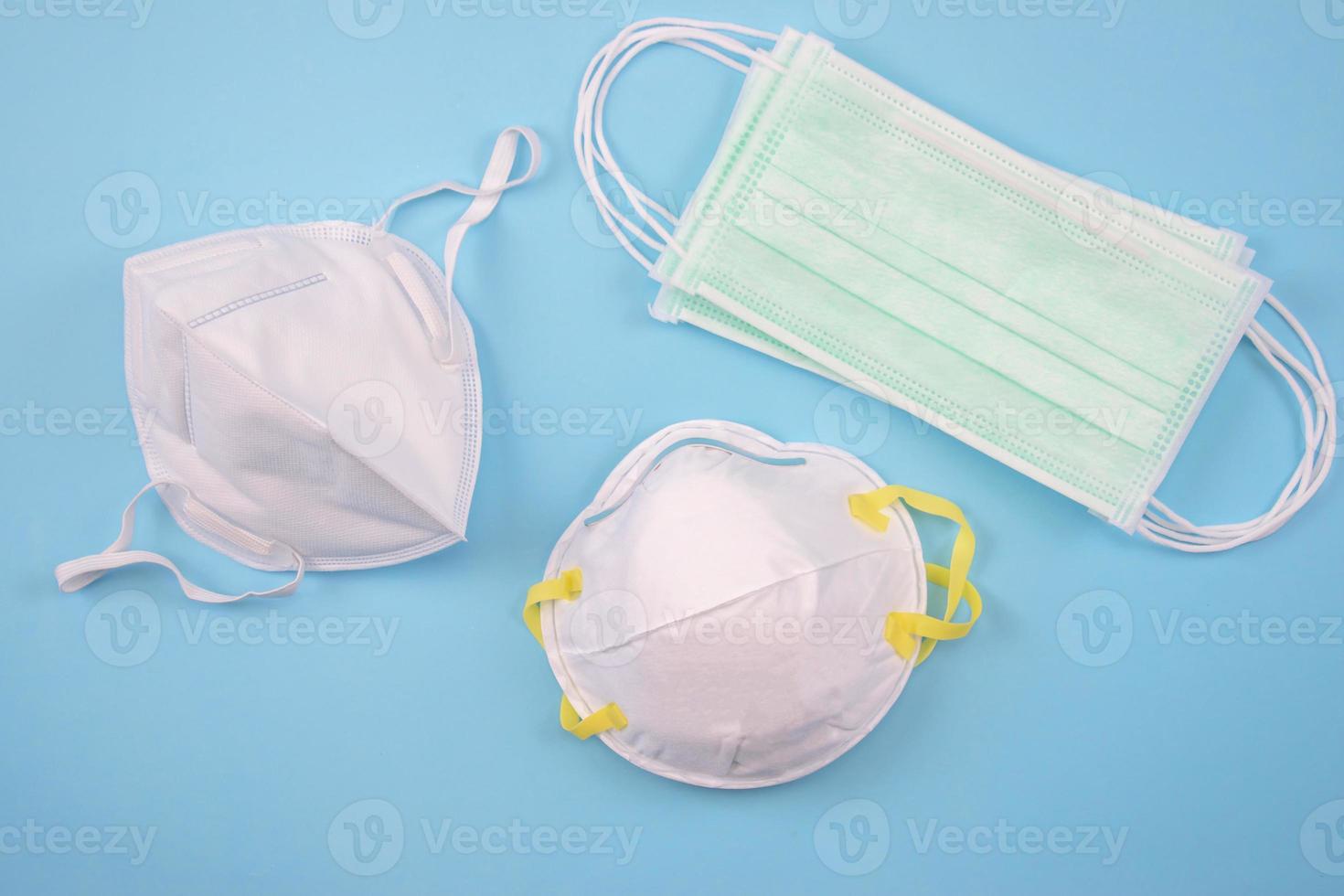 Three protective masks on a blue background, Many masks. Top view. photo