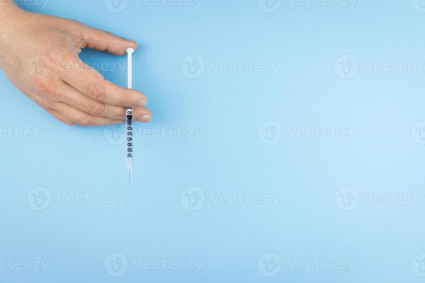 Syringe in hand photo