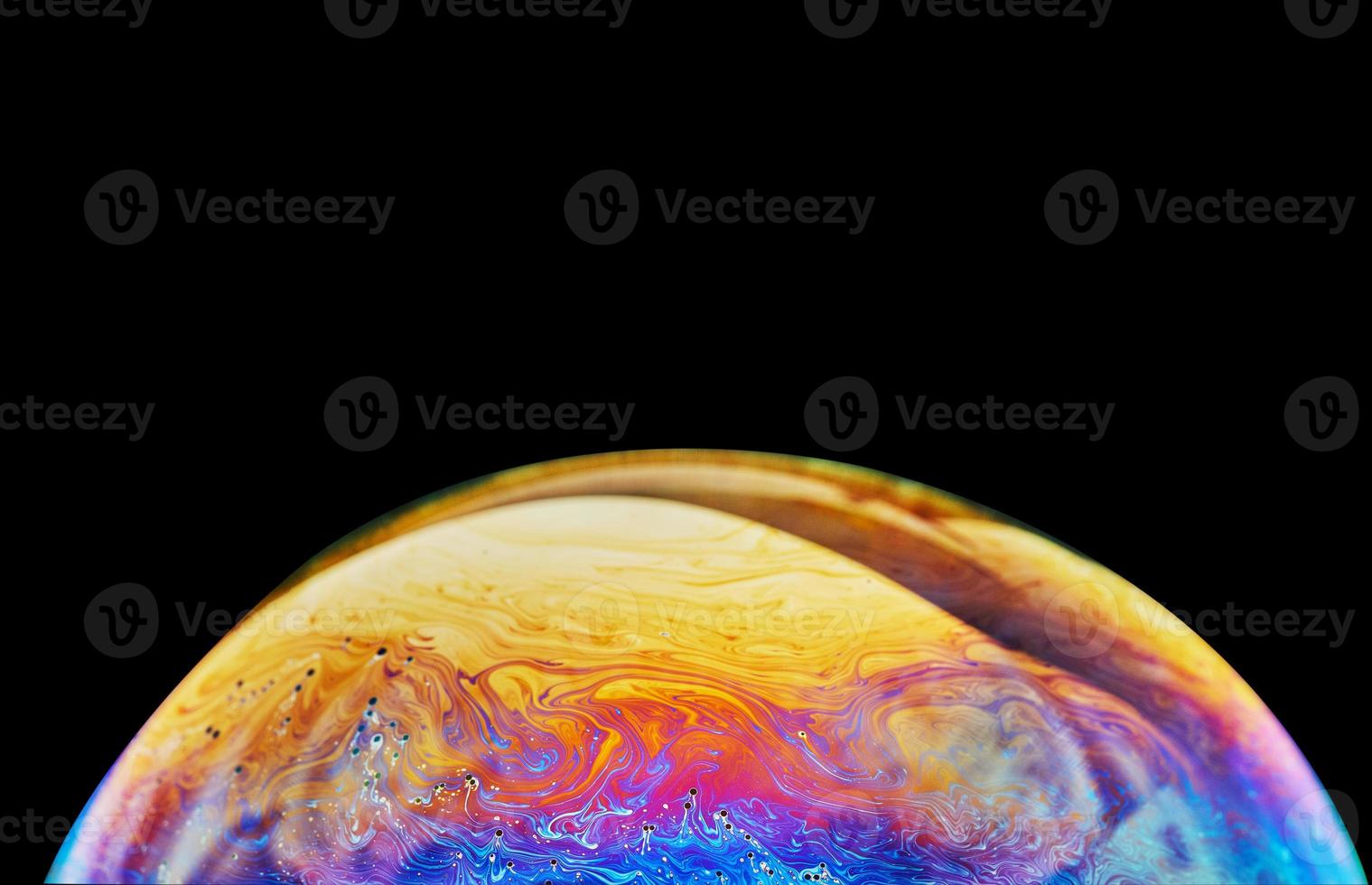 Virtual reality space with abstract multicolor psychedelic planet. Closeup Soap bubble like an alien planet on black background photo