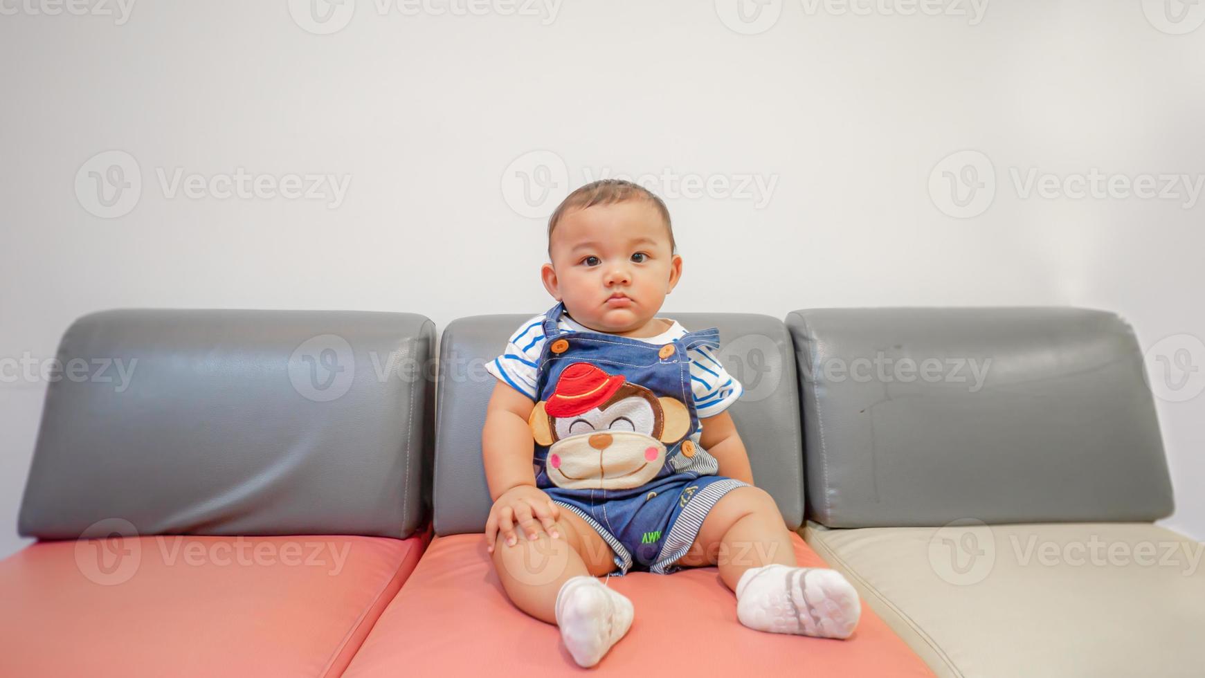 Child sitting and playing with toy smiling looking cute Focusing only on the child in the center of the picture There is a slight blur in the surrounding area intended to provide images with depth photo